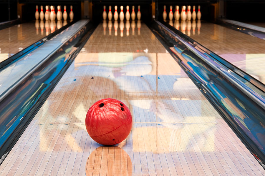Red bowling ball sitting in middle of newly oiled lane Photograph by Avdeev007