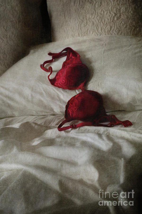 Clothing Photograph - Red brassiere lay on bed by Sandra Cunningham