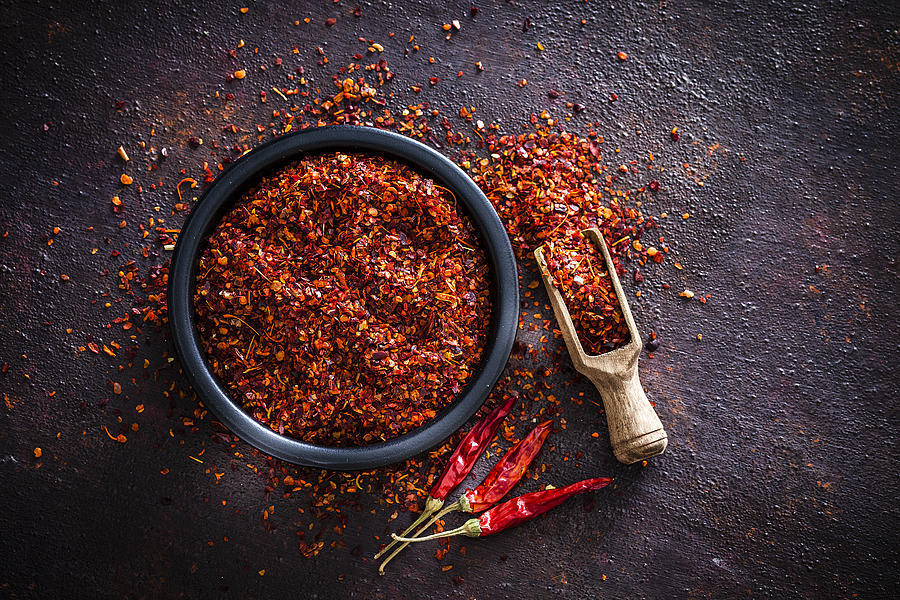 Red chili pepper flakes shot from above Photograph by Fcafotodigital
