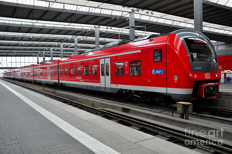 Red commuter train parked at Munich station Germany Photograph by Imran Ahmed