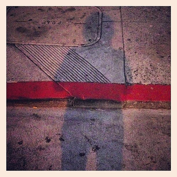 Red Curb Across Shadow Photograph by Lynn Friedman