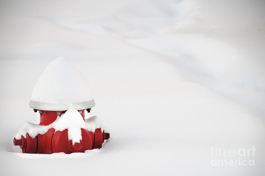 Red fired hydrant buried in the snow. Photograph by Oscar Gutierrez