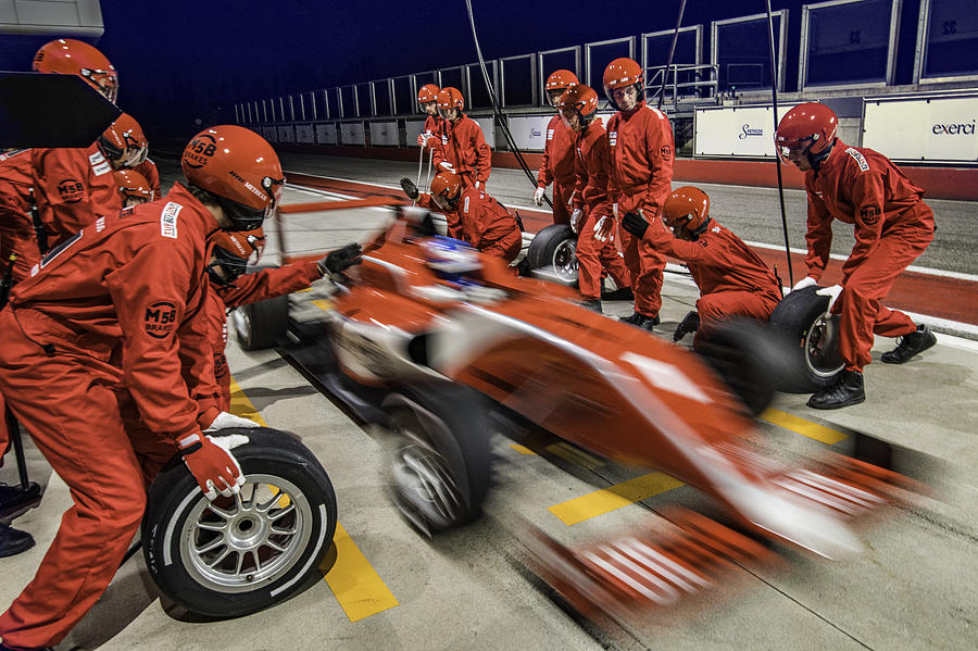 Red formula race car leaving the pit stop Photograph by Vm