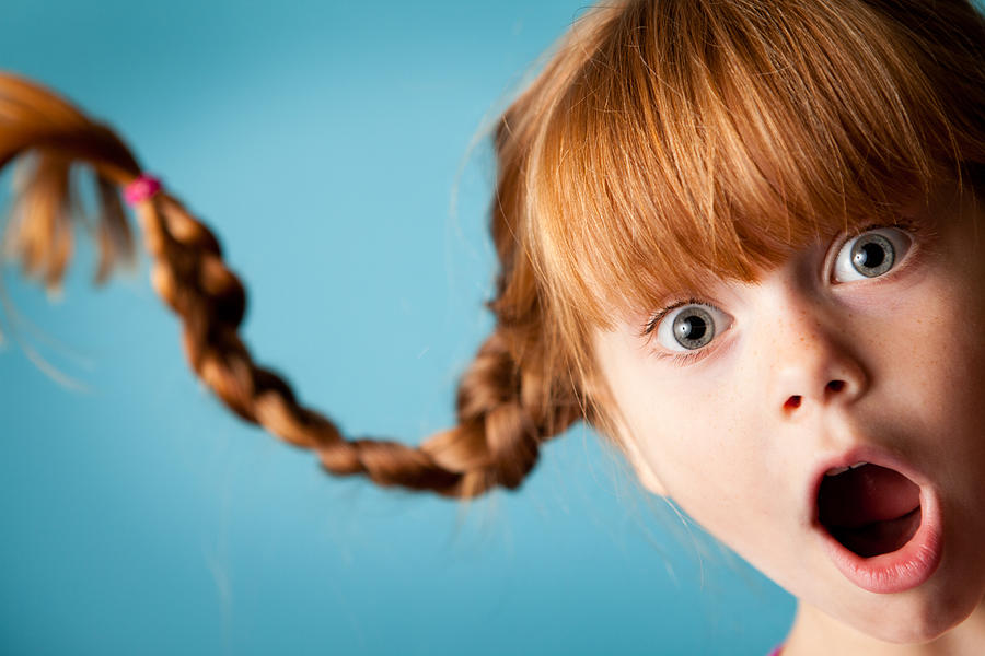 Red-Haired Girl with Upward Braids and Look of Surprise Photograph by Ideabug