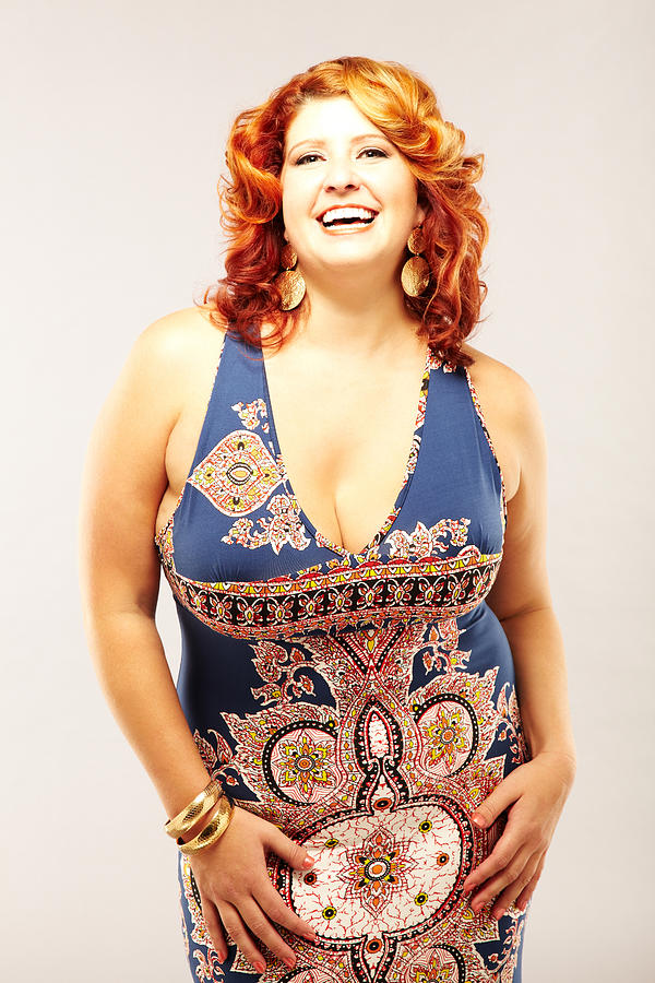 Red-Haired Woman in Blue Patterned Dress smiling at camera Photograph by GSPictures