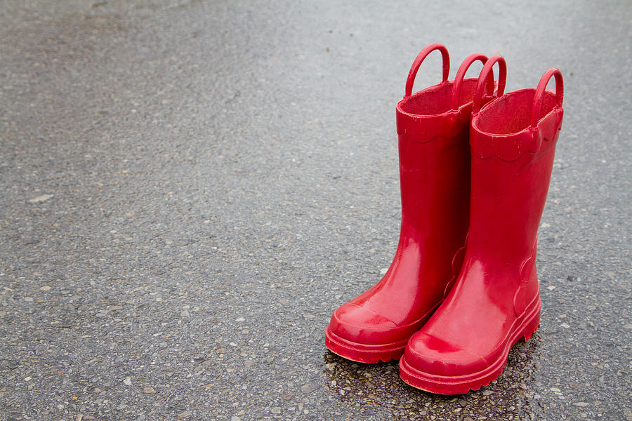 Red rain boots wet pavement Photograph by Jennifer Huls Fine Art