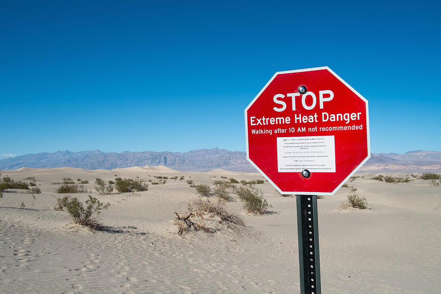Red stop sign, Stove Pipe Dunes, Death Valley, California, USA Photograph by Owen Smith
