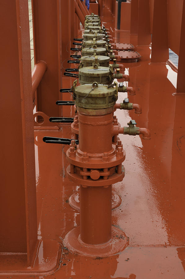 Red valves on a ship Photograph by Bradford Martin