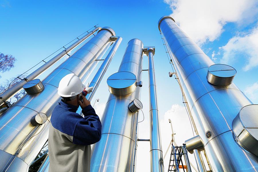 Refinery Worker And Towers Photograph by Christian Lagerek/science ...