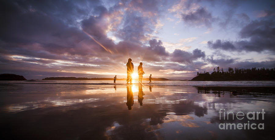 Sunset Photograph - Reflection of a Family Silhoutted in the Sunset while Playing on the Beach at Low Tide  by Dave Bryson