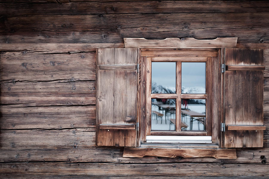 Reflection on glass window of log cabin, Kufstein, Tyrol, Austria Photograph by Sebastian Doerken