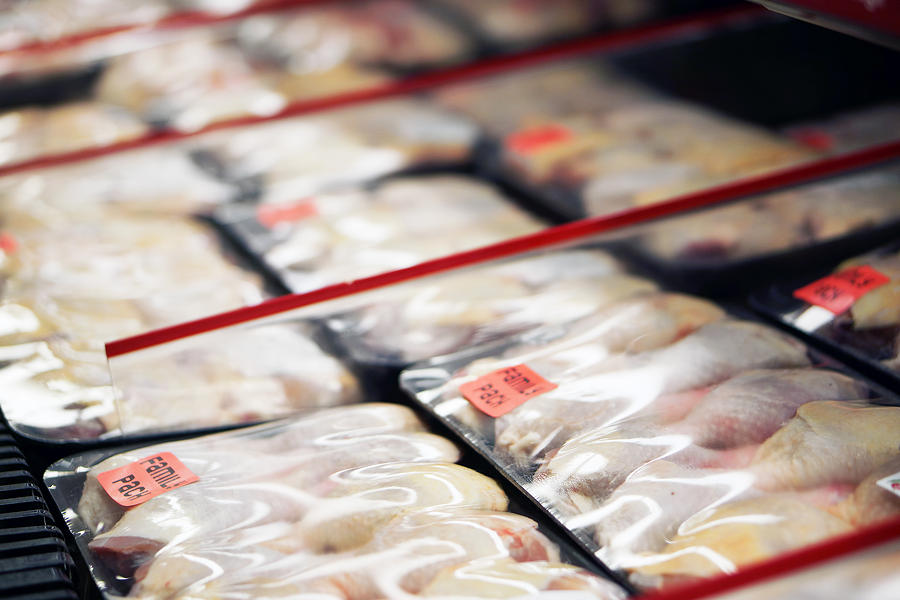 Refrigerated chicken legs in store Photograph by Fotofrog