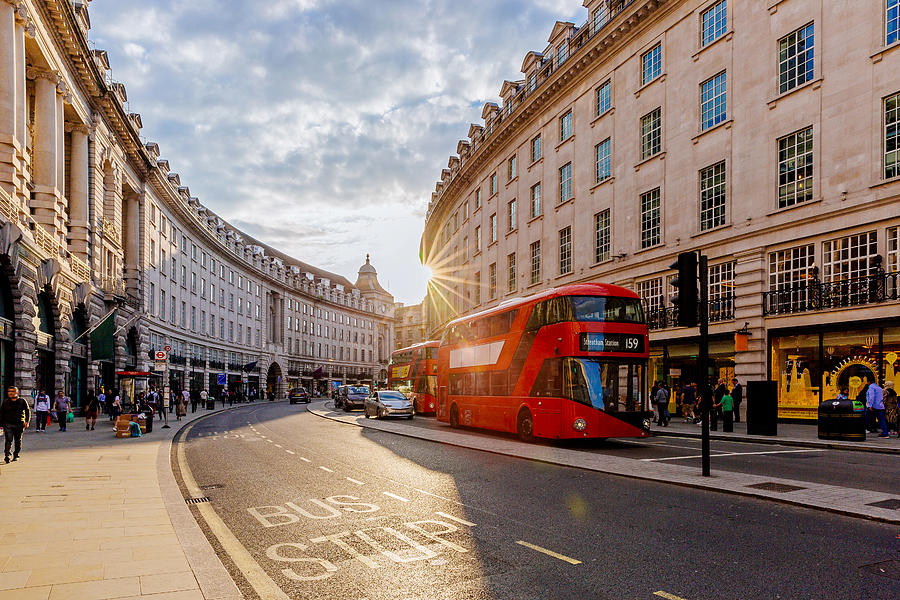 Regent Street  with sun shining through buildings during sunset, London, England, UK Photograph by Alexander Spatari