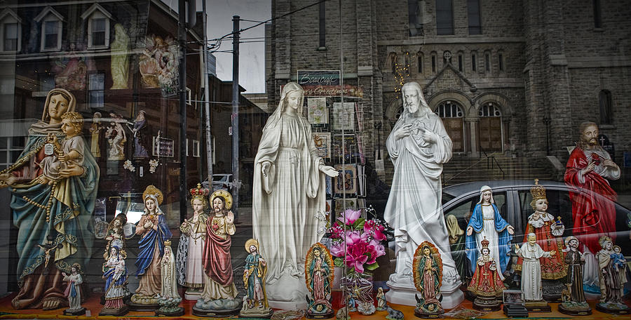Religious Figurines in window display in Toronto Photograph by Randall Nyhof