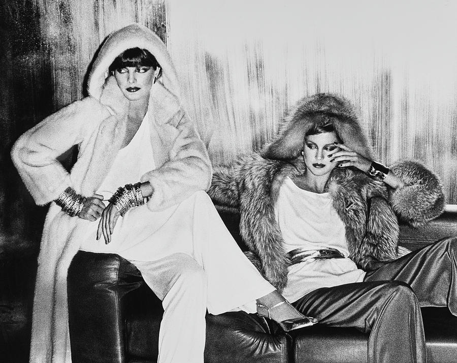 Rene Russo And Another Model Sitting In Hooded Photograph by Chris von Wangenheim