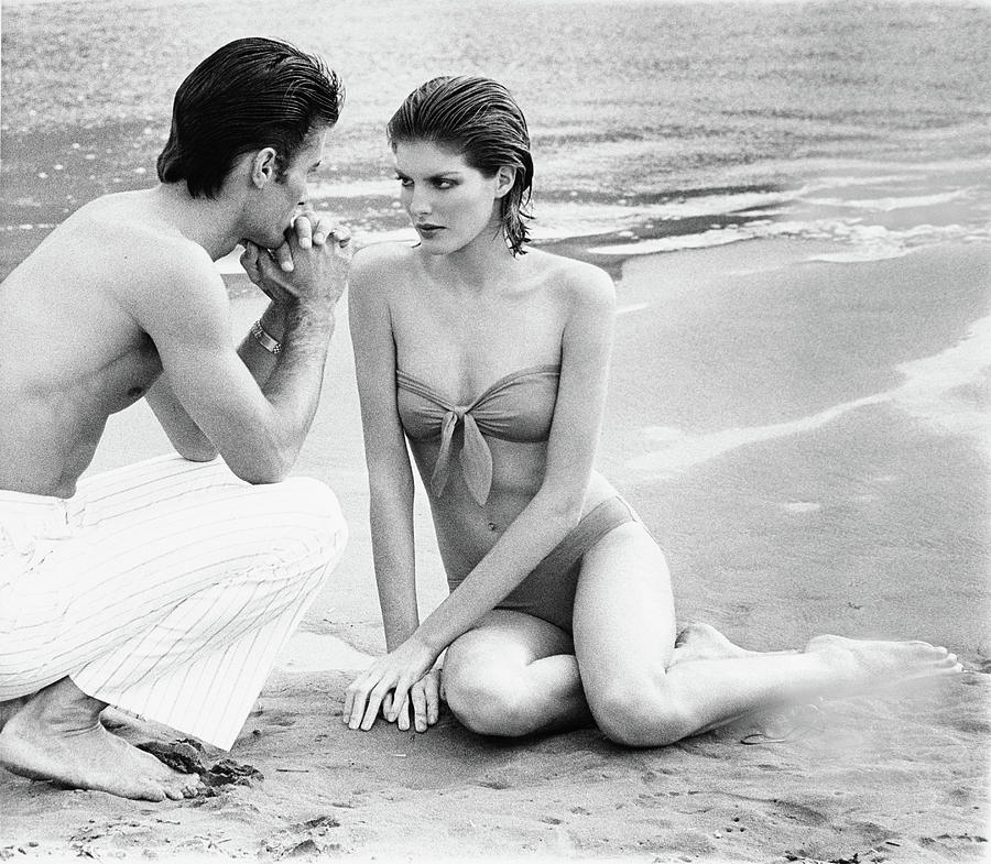 Holiday Photograph - Rene Russo With A Man On A Beach by Francesco Scavullo