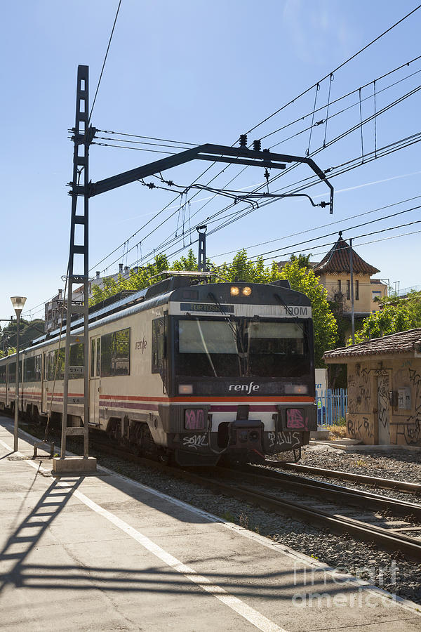 Renfe Train Approaching Platform With Overhead Power Lines Photograph by Peter Noyce