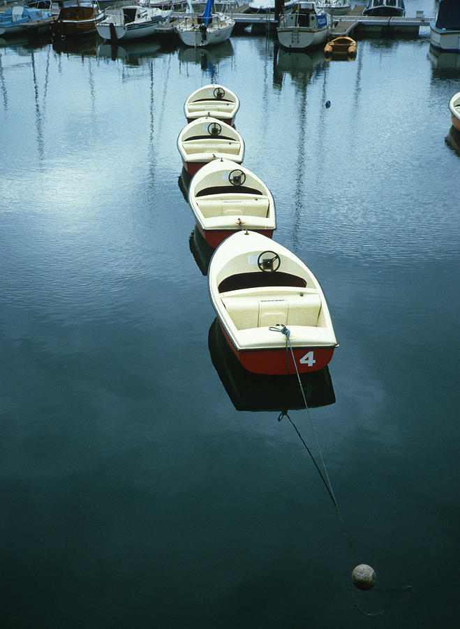 Rental Motor Boats in a Line Photograph by Gordon James