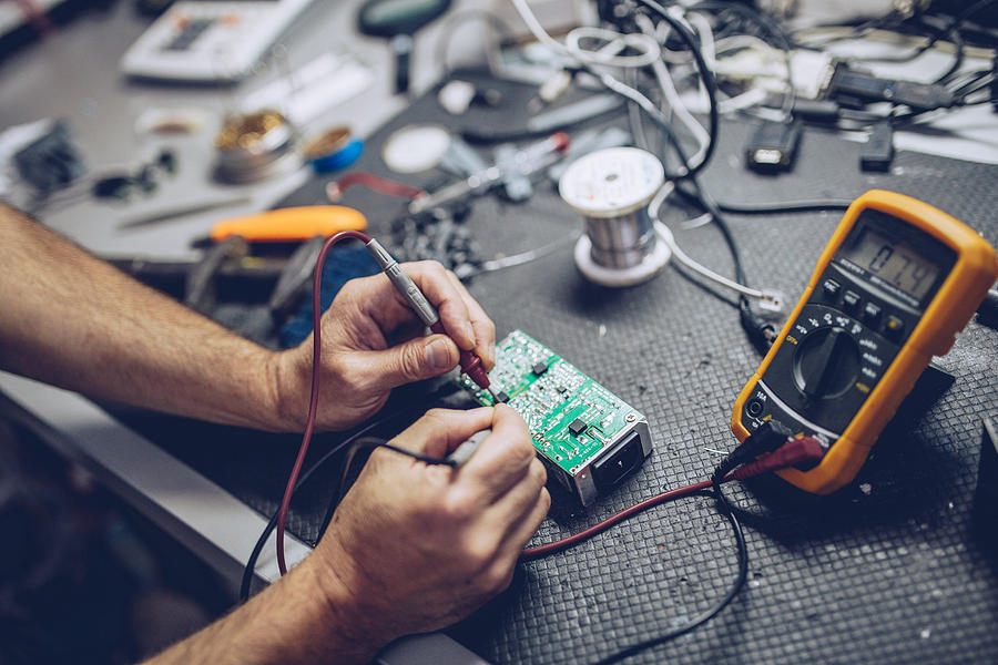 Repairman Checking Voltage With Digital Multimeter Photograph by South_agency