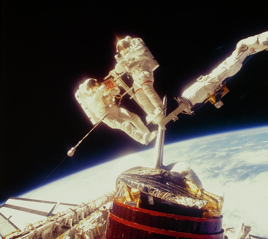 Retrieval Of Damaged Communication Satellite Photograph by Nasa/science Photo Library.
