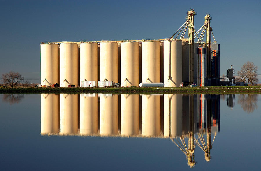 Rice Silos And Flooded Rice Field Photograph by Theodore Clutter