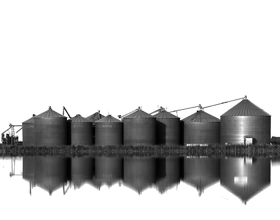 Rice Silos Reflected in a Rice Field Photograph by Robert Woodward