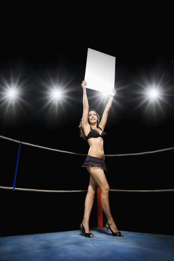 Ring girl holding sign in boxing ring Photograph by Hill Street Studios