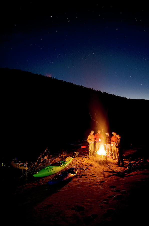 River Runners Huddle Around The Fire Photograph by Kyle George