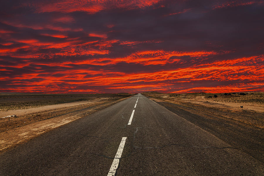 Road in the desert at sunset Photograph by Anton Petrus