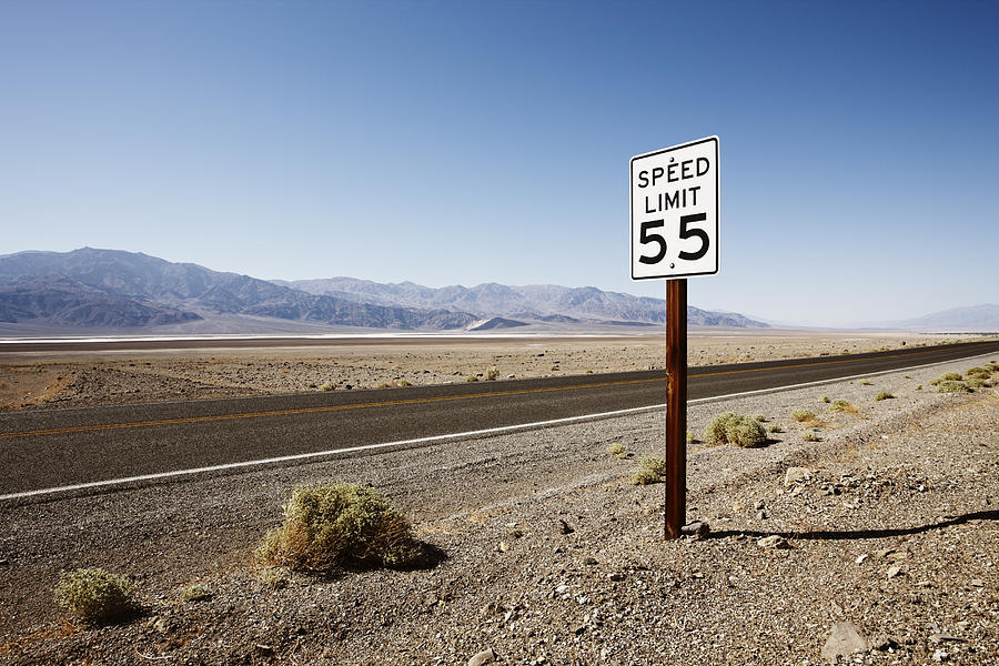 Roadside sign in desert landscape Photograph by Gary Yeowell