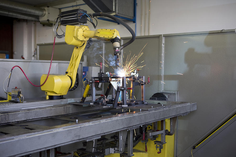 Robotic welding machine at work on a project Photograph by Pkm1