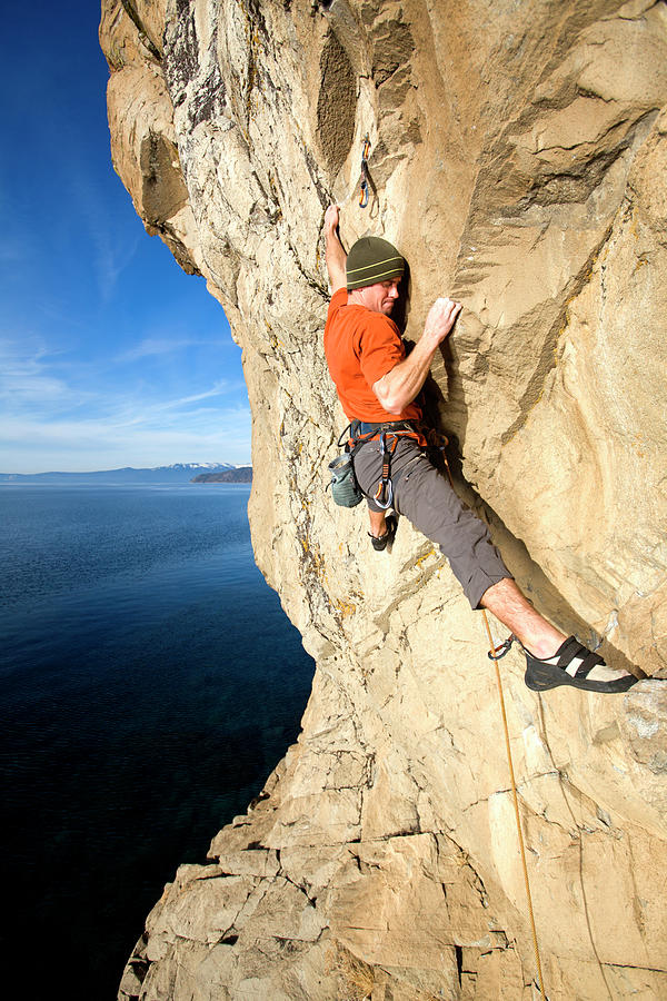 Mountain Photograph - Rock Climber Finding A Foothold by Corey Rich