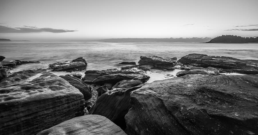 Rocks by the sea B and W Photograph by Dasmin Niriella