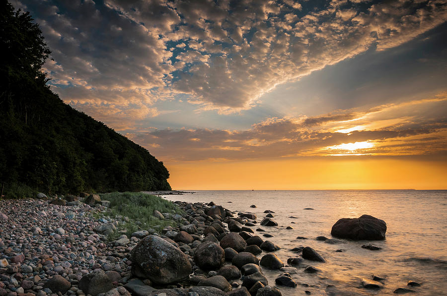 Rocks On A Beach At Sunset By The Sea Photograph by Andreas Jakel