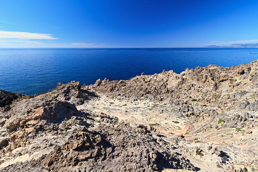 rocky coast in San Pietro island Photograph by Antonio Scarpi