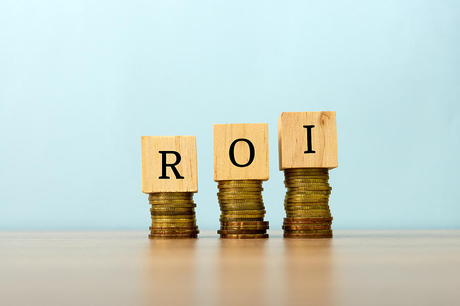 Roi Text Written On Wooden Block With Stacked Coins Nora Carol Photography