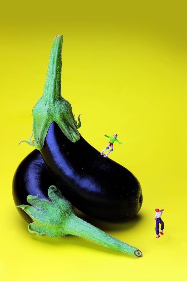 Rolling on eggplants little people on food Photograph by Paul Ge