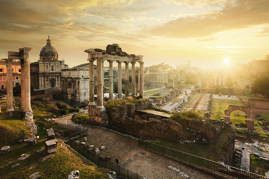 Roman Forum at sunrise, from left to right: Temple of Vespasian and Titus, church of Santi Luca e Martina, Septimius Severus Arch, ruins of Temple of Saturn. Photograph by Mammuth