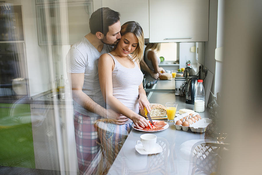 Romantic couple enjoying breakfast and romance on weekend morning. Photograph by Emir Memedovski