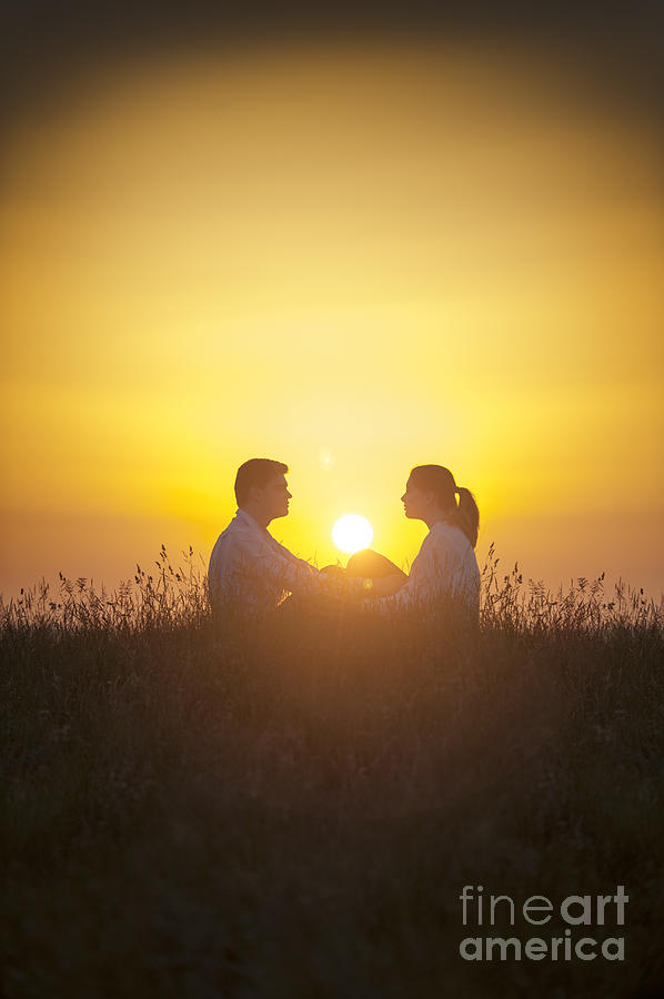 Sunset Photograph - Romantic Couple Sitting In Front Of A Setting Sun by Lee Avison