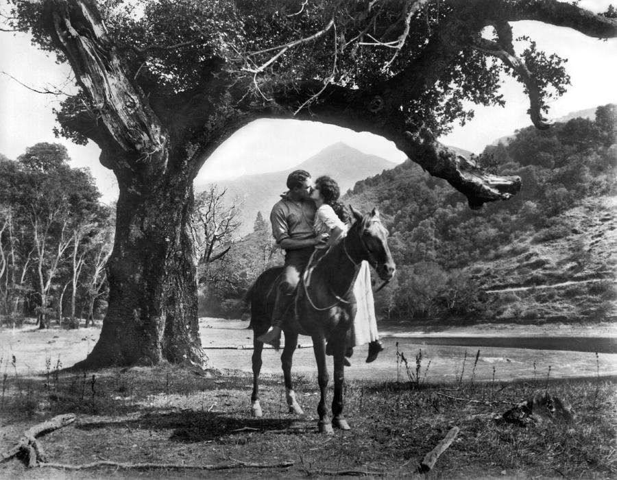 Black And White Photograph - Romantic Kiss On Horseback by Underwood Archives