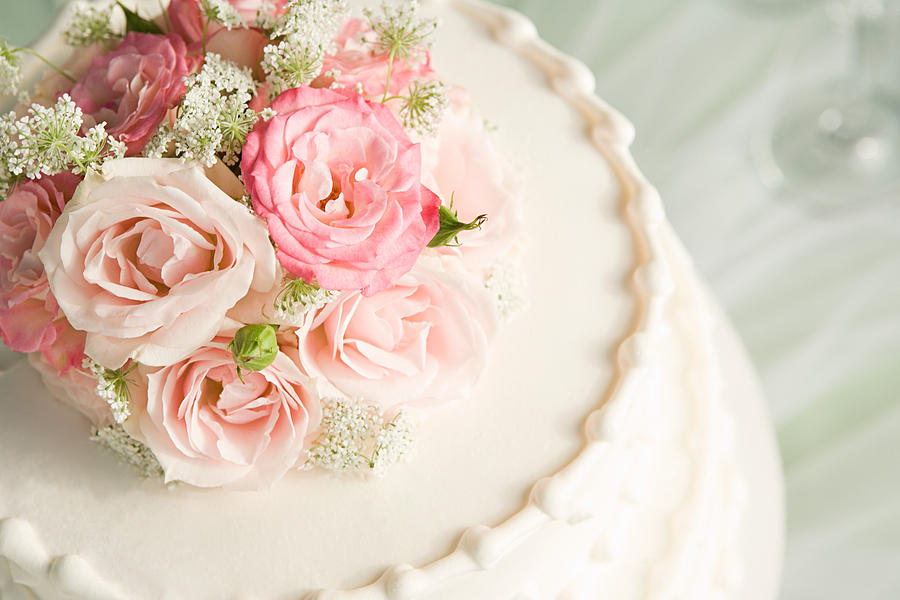 Roses on top of a wedding cake Photograph by Image Source