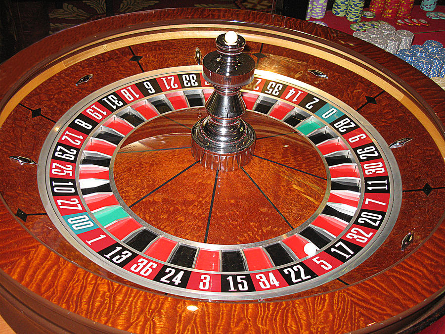 Roulette wheel and chips Photograph by Tom Conway