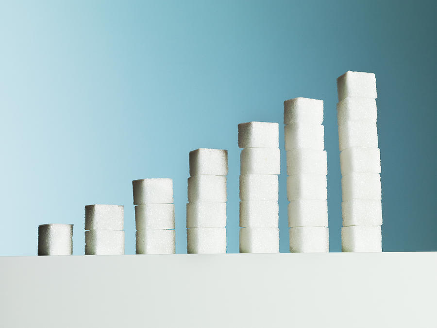 Row of ascending stacks of sugar cubes Photograph by Martin Barraud