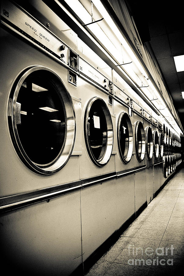 Black And White Photograph - Row of Washing Machines in Laundromat by Amy Cicconi