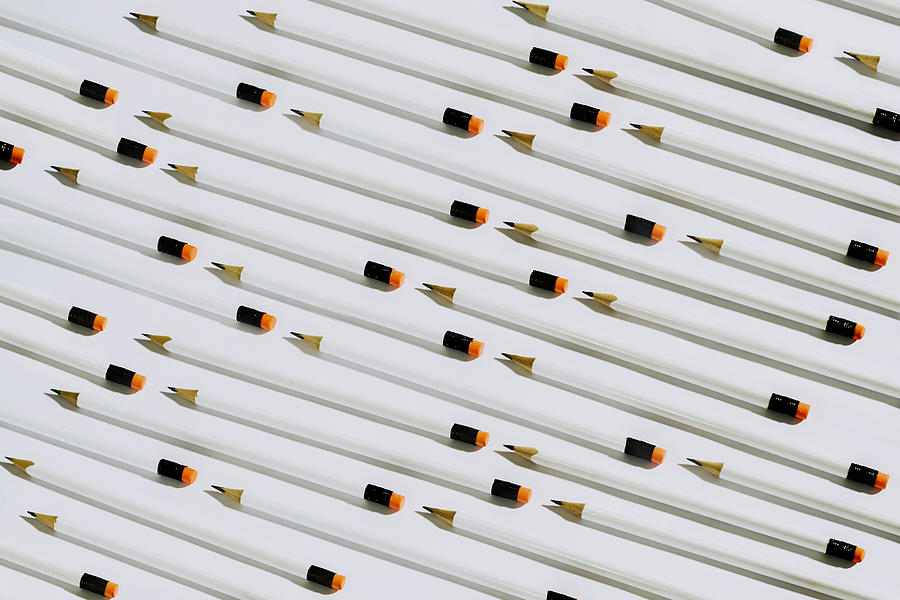 Row of white pencils lying on a white background Photograph by Emilija Manevska