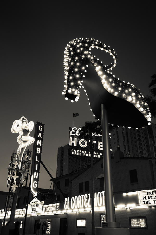 Architecture Photograph - Ruby Slipper Neon Sign Lit Up At Dusk by Panoramic Images
