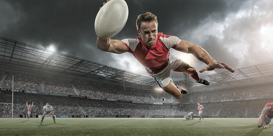Rugby Player Diving in Mid Air About To Score Photograph by Peepo