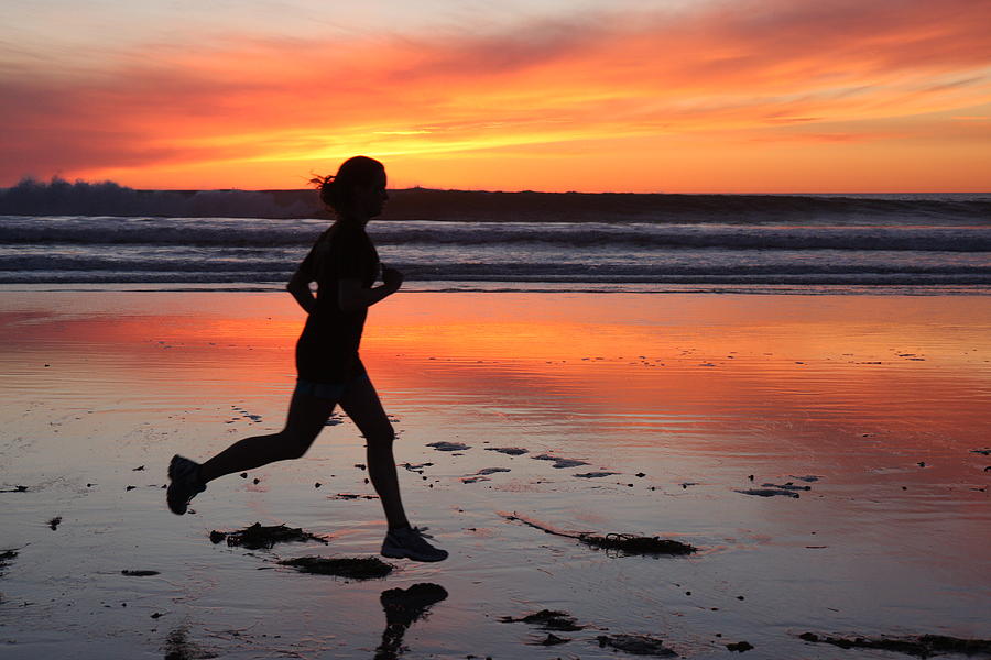 Runner at sunset Photograph by Nathan Rupert