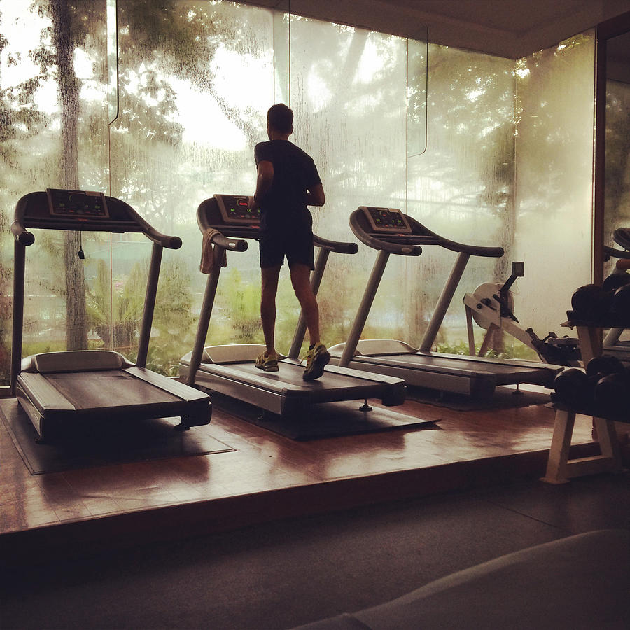 Runner on treadmill in a gym Photograph by Anshu Ajitsaria